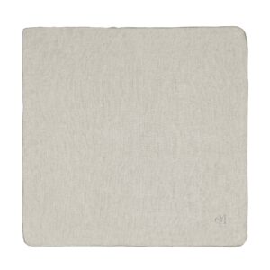 Het Marc O'Polo Valka-servet in de kleur Oatmeal is een lichtbeige linnen servet met nette randen en een subtiel monogram in de hoek.