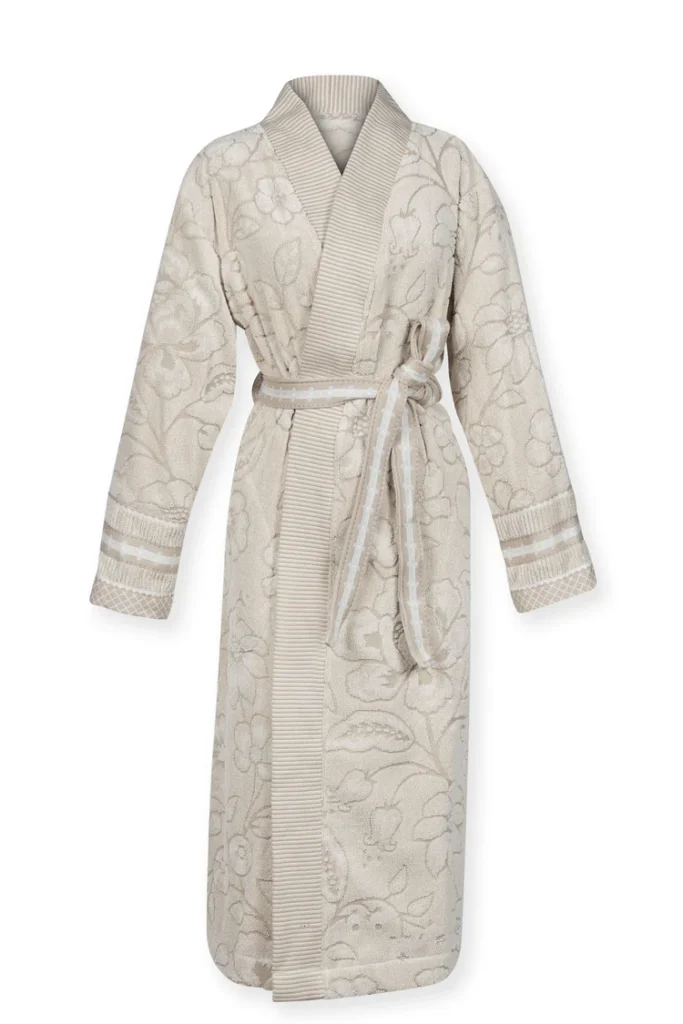 De Pip Studio Jasmin Jacquard badjas Sand L is een beige badjas met bloemenprint, sjaalkraag, ceintuur en verfijnde textuurdetails.